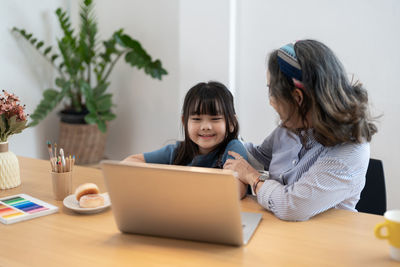 Young woman using laptop at home