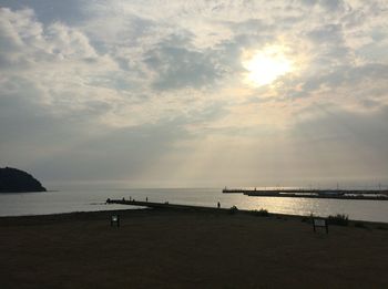 View of beach against cloudy sky