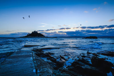 Scenic view of sea against sky during sunset