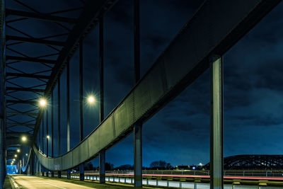 Illuminated bridge against sky at night