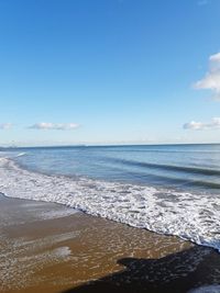 View of beach against blue sky