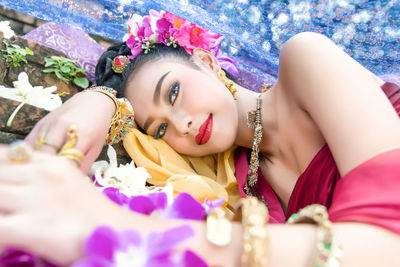 Portrait of beautiful young woman lying down