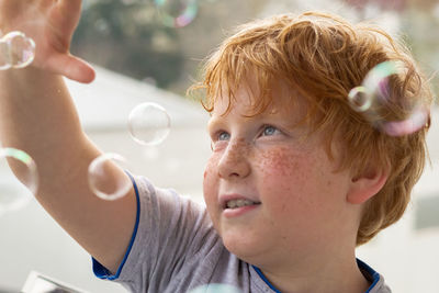 Close-up portrait of boy looking away outdoors