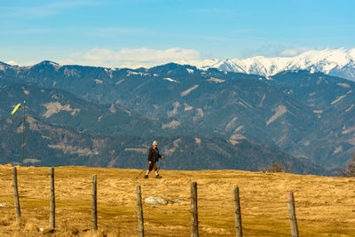 Man on field against mountains