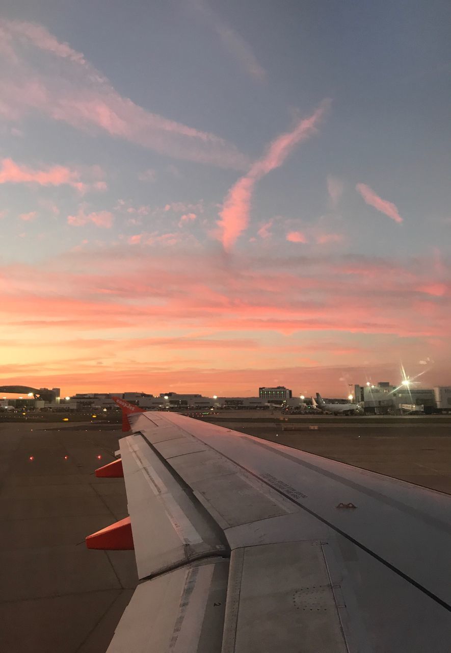 AIRPORT RUNWAY AGAINST SKY DURING SUNSET