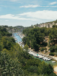 High angle view of river amidst trees against sky