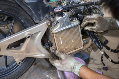 High angle view of man holding motorcycle