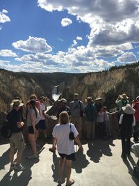People standing on landscape against sky
