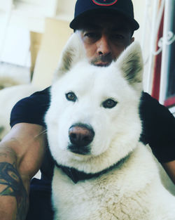 Portrait of man with dog at home