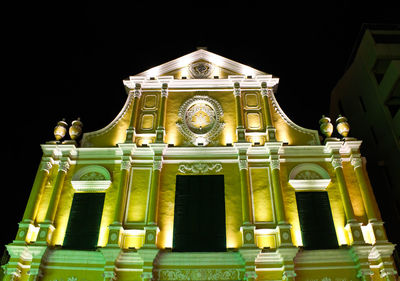 Low angle view of illuminated building at night