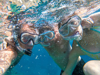 Portrait of friends snorkeling in sea