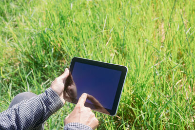 Man using mobile phone in field