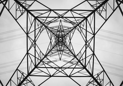 Low angle view of electricity pylon against clear sky
