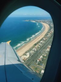 Aerial view of sea seen through airplane window