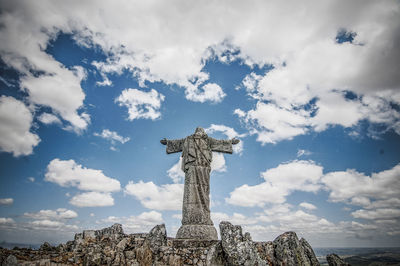 Low angle view of angel statue against sky