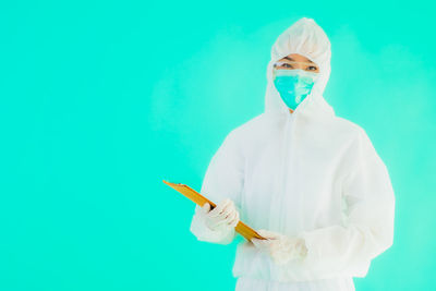 Full length of a man standing against blue background