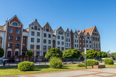 Residential buildings against clear blue sky