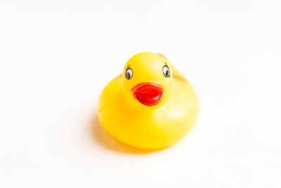 Close-up of yellow toy over white background