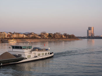 Scenic view of river by buildings against clear sky