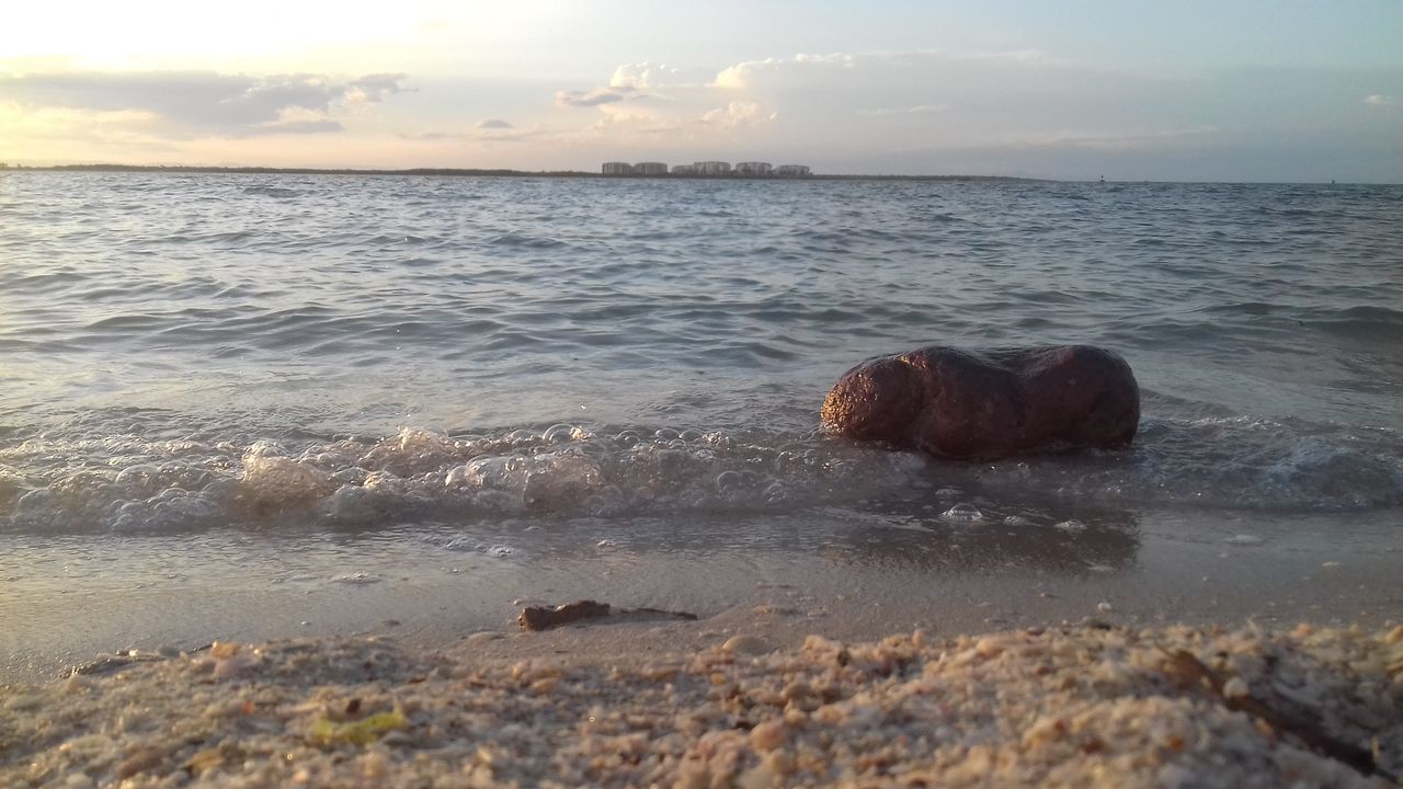 water, sea, scenics, beach, tranquil scene, horizon over water, beauty in nature, tranquility, nature, shore, sky, rock - object, wave, pebble, rippled, cloud, seascape, non-urban scene, majestic, outdoors, cloud - sky, tide, remote, day, summer, coastline, surface level, vacations, rock formation