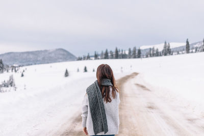 Portrait of woman standing on snow covered landscape