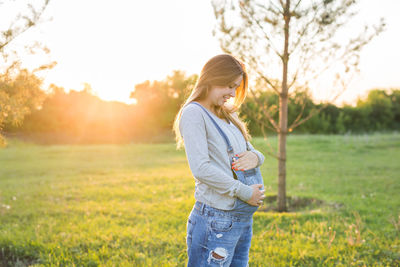 Side view of woman standing on field