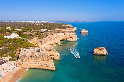 High angle view of sea and rock formations against sky