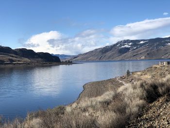 Scenic view of lake and mountains against sky