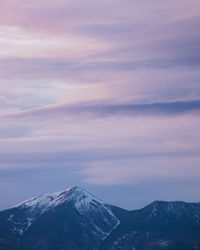 Scenic view of snowcapped mountains against sky during sunset