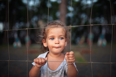 Portrait of cute girl holding outdoors