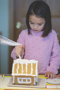 Girl preparing dessert on table