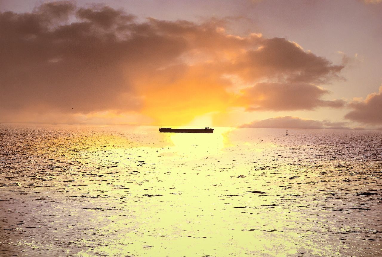 sunset, water, sea, horizon over water, sky, scenics, tranquil scene, tranquility, beauty in nature, orange color, nautical vessel, cloud - sky, transportation, boat, nature, idyllic, mode of transport, silhouette, waterfront, reflection