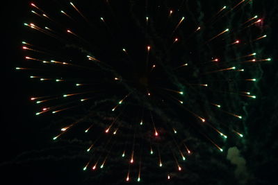 Low angle view of firework display at night