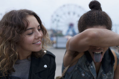 Friends hanging out at a boardwalk amusement park