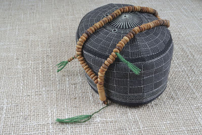 High angle view of rosary beads on hat in mosque