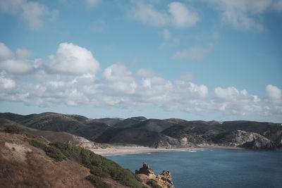 Scenic view of sea and mountains against sky