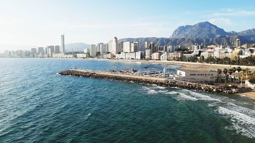 Scenic view of sea and buildings against sky