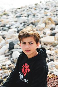 Portrait of boy standing on rock