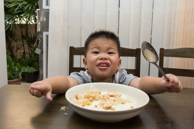 Portrait of cute boy having food