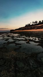 Scenic view of beach against sky during sunset