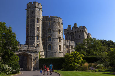 People walking in front of historical building