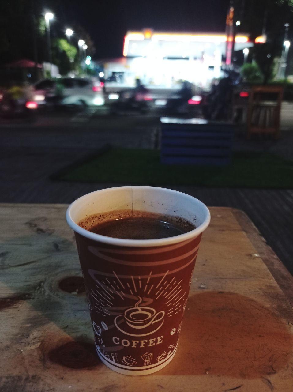drink, food and drink, cup, refreshment, mug, coffee, focus on foreground, city, coffee cup, street, table, hot drink, car, no people, night, lighting, vehicle, food