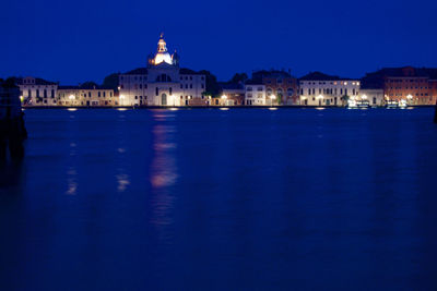 Illuminated buildings with waterfront at night