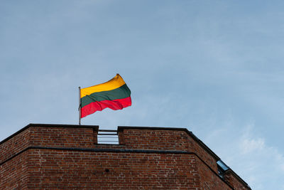 Low angle view of flag against blue sky