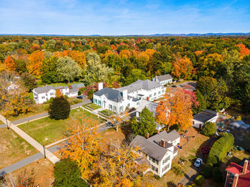 High angle view of trees and buildings against sky during autumn