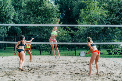 Beach tennis players at the net