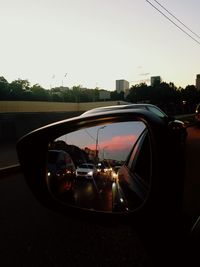 Reflection of car on road in side-view mirror