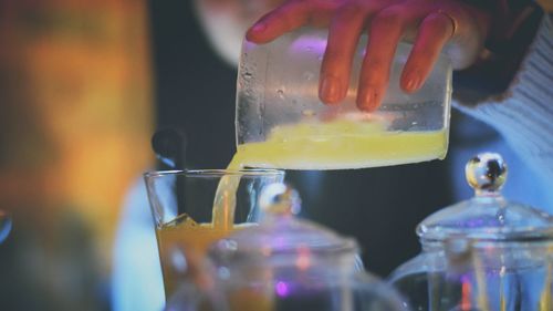 Cropped image of bartender preparing drink