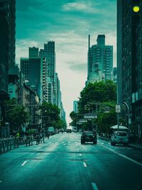 City street and buildings against sky