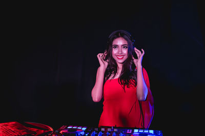 Smiling dj playing music in nightclub